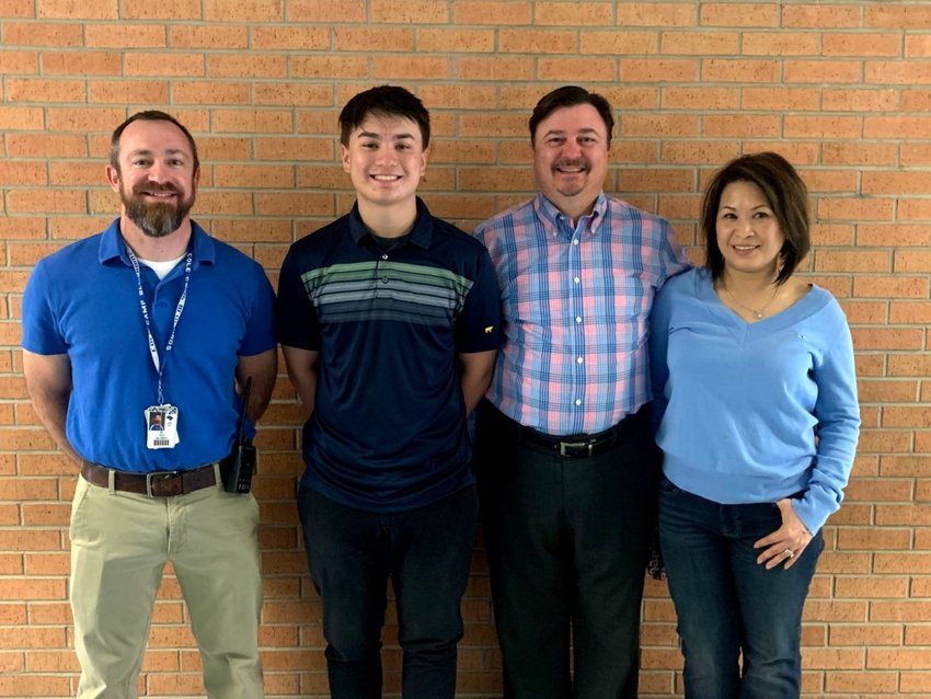 From left, Cole Camp Middle School Principal Tyler Clark, Cole Camp senior Keegan Vosmith, Drew Smith and Thao Vo-Smith pose for a photo recently. Vosmith received an honorable mention for the 2021 Missouri Scholars 100.