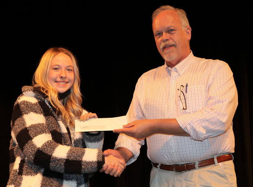 Smith-Cotton High School senior Natalie Adermann is presented a $1,000 scholarship by Sedalia School District 200 Board President Dr. Jeff Sharp during Monday&rsquo;s meeting in the Heckart Performing Arts Center. An anonymous donor provided funds for the scholarship, presented in Sharp&rsquo;s name to a student entering the health or medical field. Adermann plans to attend the University of Missouri-Kansas City to study pharmacy.