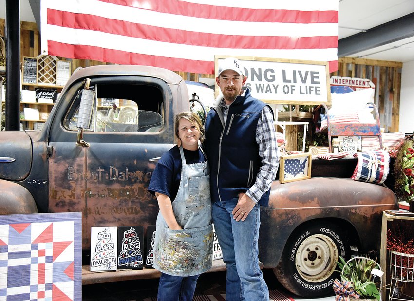RiOak Western Design owners Ashley and Clinton Raetz stand in their newly opened 3,000-square-foot storefront Saturday beside a display with a 1952 Ford truck. RiOak hosted its grand opening Saturday after moving the business from Cheese Creek Road to Maple Street in downtown Cole Camp.
