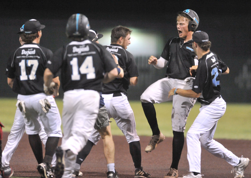 Sedalia Bombers first baseman Brayden McGinnis, second from right, celebrates his game-winning single Wednesday during a 7-6 victory over the Chillicothe Mudcats at Liberty Park Stadium in Sedalia.