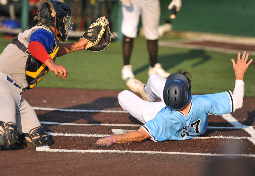 Sedalia Bombers shortstop Brandon Stahlman slides home Tuesday during a 14-2 victory against the Nevada Griffons at Liberty Park Stadium in Sedalia.