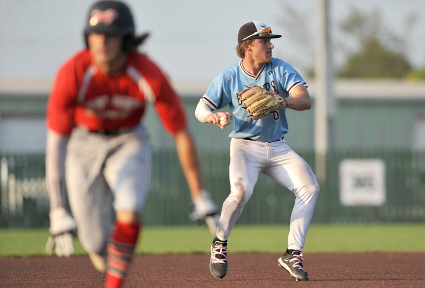 Sedalia Bombers shortstop Spencer Nivens prepares a throw Wednesday during a MINK League Championship series contest against the St. Joseph Mustangs at Liberty Park Stadium in Sedalia.