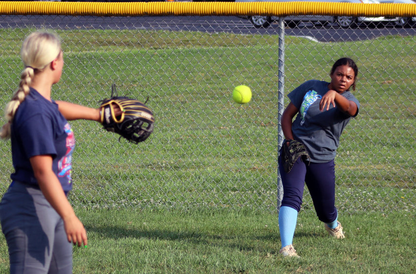 Kylah Hawkins, right, flips a throw to Grace West during drills on Monday morning as part of the first practice of the 2021 season for the Smith-Cotton High softball team at Centennial Park. The Lady Tigers are led by new Head Coach Amy Miller, who was an assistant coach last season.