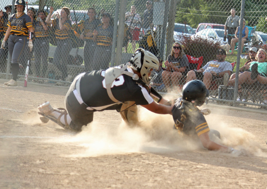 Warrensburg senior Molly Nicas tags out Smith-Cotton sophomore Savannah Ditzfeld out on what would&rsquo;ve been a game-tying run in the second inning on Monday, Aug. 30 at Centennial Park.