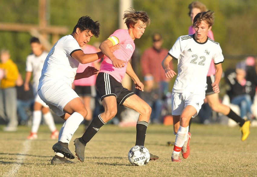 Smithton junior Braedon Cairer works to keep possession in the first half of Thursday&rsquo;s match against Sacred Heart.