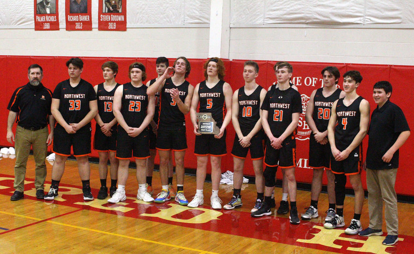Northwest&rsquo;s boys basketball team poses for a team photo Saturday after winning the Class 1 District 9 championship at Sacred Heart in Sedalia last season.