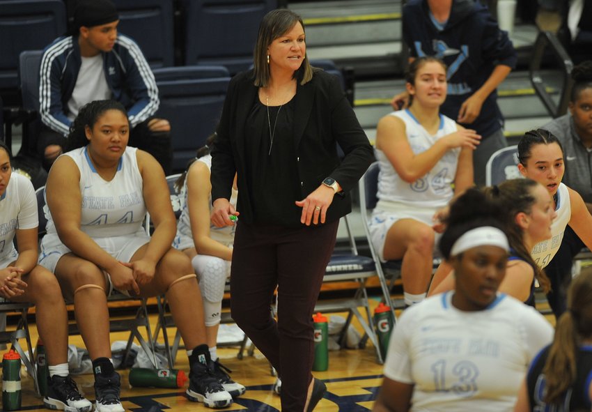 First-year head coach Nicole Collier patrols the sidelines in the first half of a home doubleheader.