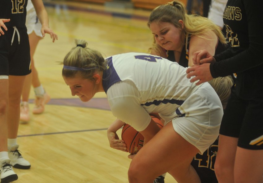 Lady Eagles junior Katie McKinney wrestles for control of the ball in Monday&rsquo;s win at the Otterville Holiday Classic.