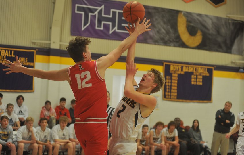 Lincoln&rsquo;s Mack Hesse gets a hand to Tom Tripp&rsquo;s shot in Sunday&rsquo;s boys&rsquo; title game of the Otterville Holiday Classic.