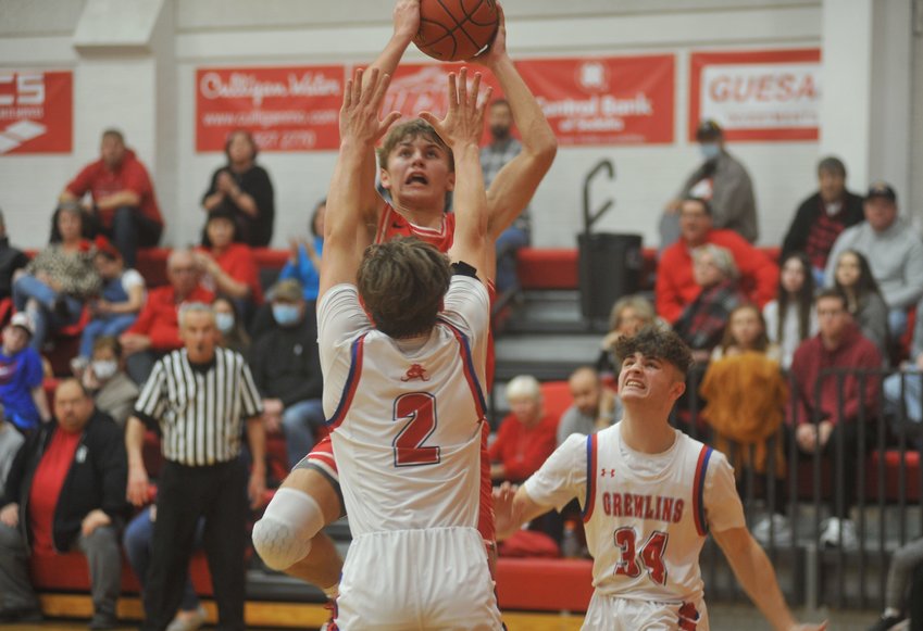 Lincoln junior Connor Lynde hangs over Gremlins junior Tanner Damlo for a shot in the first half of Tuesday night&rsquo;s 49-46 win over Sacred Heart.