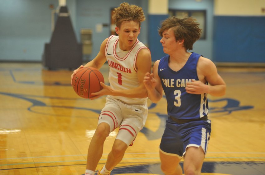 Lincoln&rsquo;s Kaleb Mundy attempts to drive past Cole Camp&rsquo;s Grady Strathman in the second half of Tuesday&rsquo;s Kaysinger Conference Boys Tournament semifinal.
