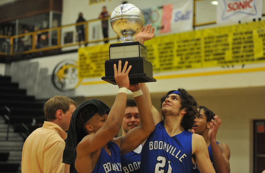 Boonville players hold up the W-K Boys Cup following Friday night&rsquo;s 55-43 victory over Smith-Cotton in Sedalia.