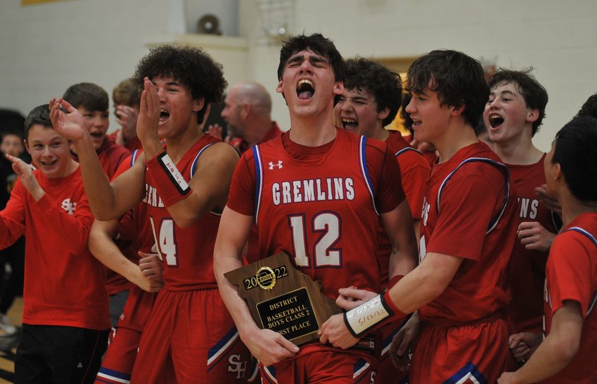 Sacred Heart senior Coen Brown and teammates celebrate winning Saturday night&rsquo;s Class 3 district final at Smithton High School.