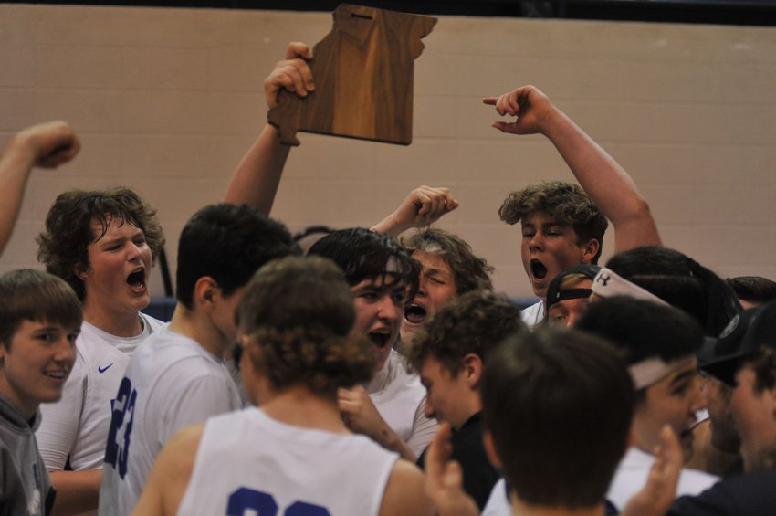 Cole Camp players celebrate with the trophy at the conclusion of Saturday&rsquo;s triple-overtime win over Stover in a Class 2 district title game.