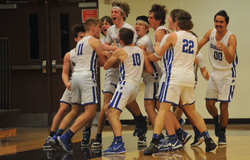 Cole Camp teammates mob junior Ethan Shearer after his game-winning 3-pointer at the horn to win Wednesday night&rsquo;s Class 3 sectional in Sedalia.