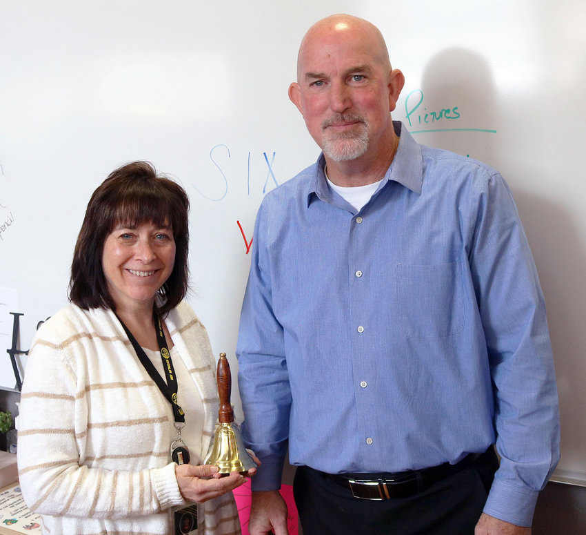 Sedalia School District 200 Superintendent Steve Triplett, right, presents Whittier High School teacher Jennie Guerrini with the Superintendents&rsquo; Bell Ringer Award on Monday, April 25, at the school.