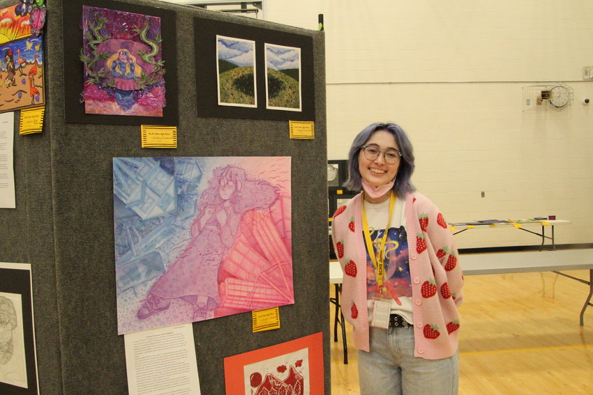 On Wednesday, Smith-Cotton High School junior Gabby Glamkowski stands by multiple pieces she has done throughout the year. One of them includes her choice of medium: watercolor and colored pencils.
