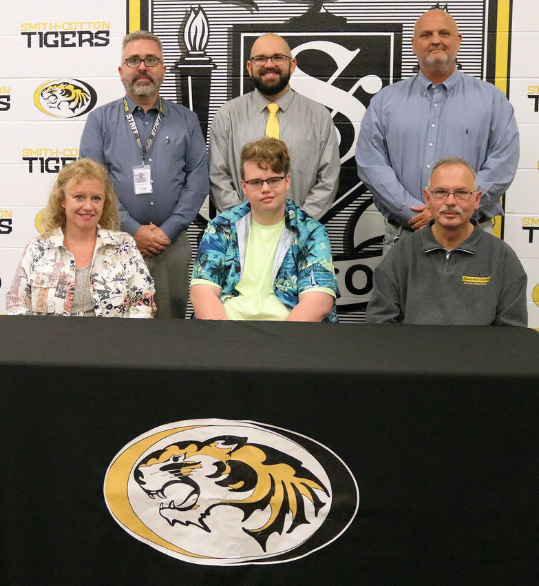 Smith-Cotton High School senior Caden Brewington has accepted a scholarship to perform with musical ensembles at the University of Missouri in Columbia. Seated with him are his parents, Amy and Lloyd Brewington; behind them are, from left, Smith-Cotton Principal  Wade Norton, Sedalia 200 Band Director Max Meigel, and Activities Director Rob Davis.