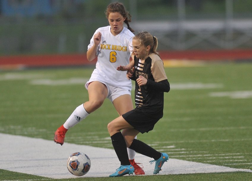 Smith-Cotton&rsquo;s Lyvia Halvorsen and Rock Bridge&rsquo;s Amelie Craine tangle for possession in the junior varsity game at Tiger Stadium Monday night. Rock Bridge defeated S-C 4-1 in the varsity match, while the JV game was abbreviated and ended scoreless due to inclimate weather.