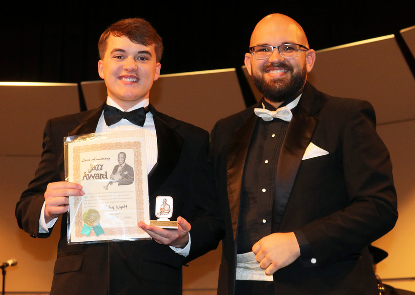 Smith-Cotton High senior Riley Wyatt, left, receives the Louis Armstrong Jazz Award from S-C Band Director Max Meigel during the Spring Band Concert on May 12 in the Heckart Performing Arts Center.