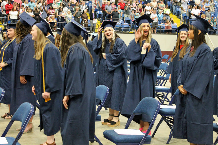 Soon-to-be State Fair Community College graduates smile and wave to loved ones in the audience shortly after finding their seats in the Mathewson Exhibition Center on the Missouri State Fairgrounds for the 53rd annual commencement ceremony on Friday, May 6.