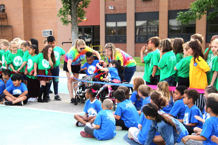 Two students cut the ribbon for the inclusive playground Tuesday morning at Heber Hunt Elementary. The inclusive playground is part of the first- and second-grade students&rsquo; service learning day project.