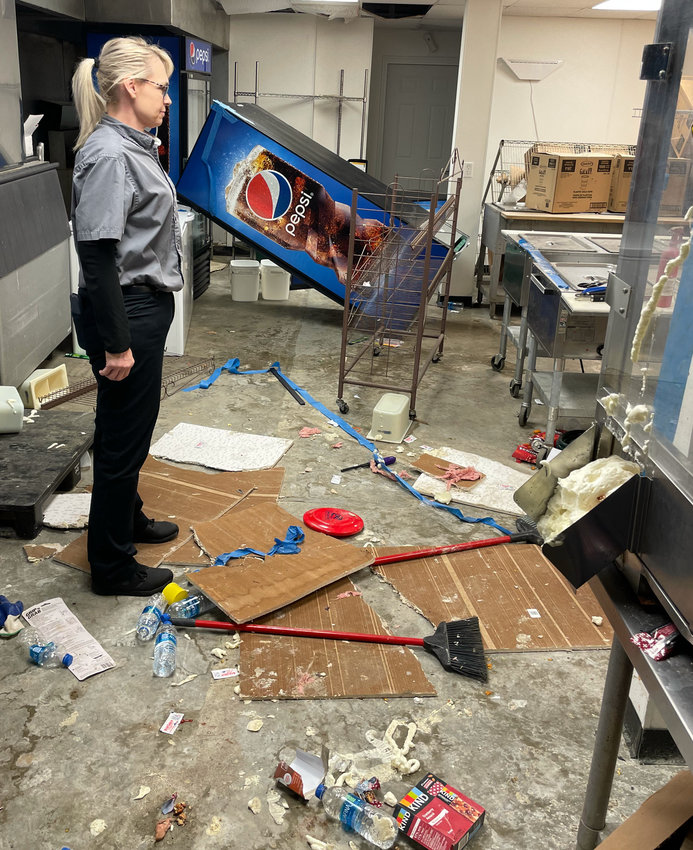 On Monday, Suzie Simons with Guesa USA examines the destruction by vandals to the State Fair Grandstand concession stand.