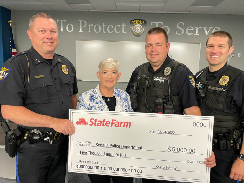 Sedalia Police Chief Matt Wirt, State Farm Agent Margaret Ward, Officer Nick Camirand and Sgt. Mike Elwood are pictured as Ward&rsquo;s office donates $5,000 to the Sedalia Police Department&rsquo;s Drone Unit on Tuesday.
