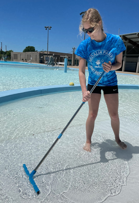 Lifeguard Makenzie Moulton does final cleaning at Liberty Park Pool on Friday for the pool&rsquo;s Memorial Day weekend opening.