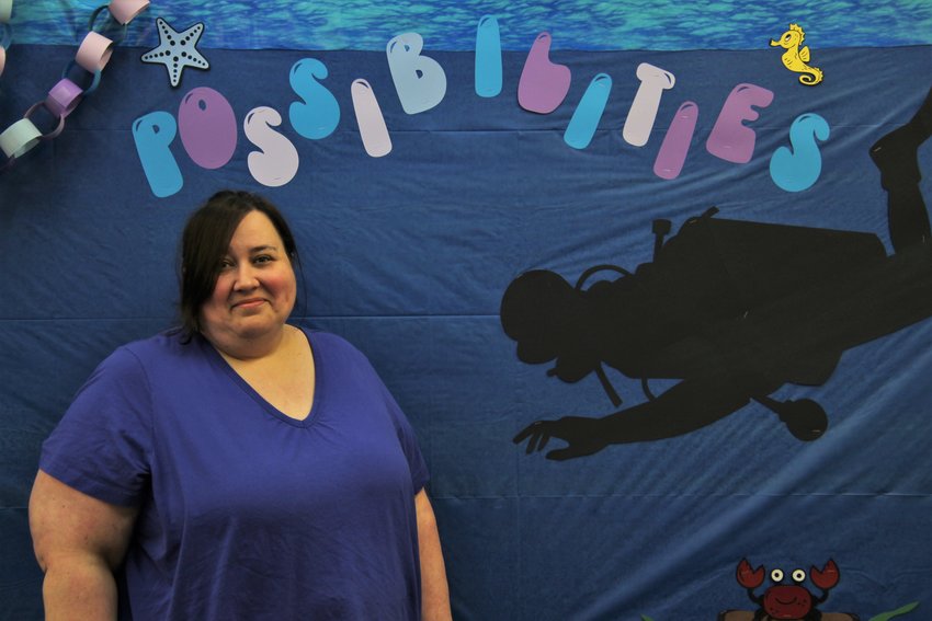 Sedalia Boonslick Regional Library Children&rsquo;s Librarian Catie McLaughlin stands in front of an &ldquo;Oceans of Possibilities&rdquo; backdrop in the children&rsquo;s department. Boonslick&rsquo;s program will begin on June 1 and McLaughlin hopes to feature many hands-on activities.