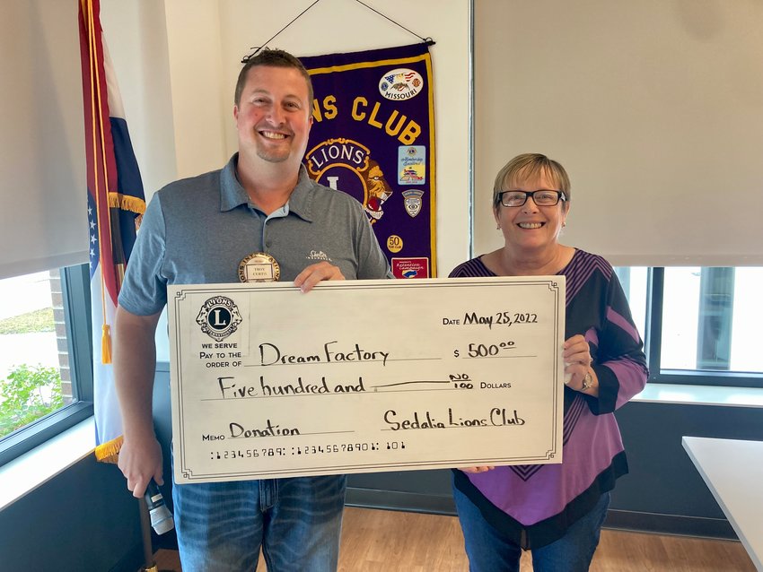 Sedalia Lions Club President Troy Curtis, left, presents a $500 check to Linda Johnson. Johnson volunteers for the Sedalia Chapter of the Dream Factory and gave a presentation to club members during a recent meeting at the Heckart Community Center.