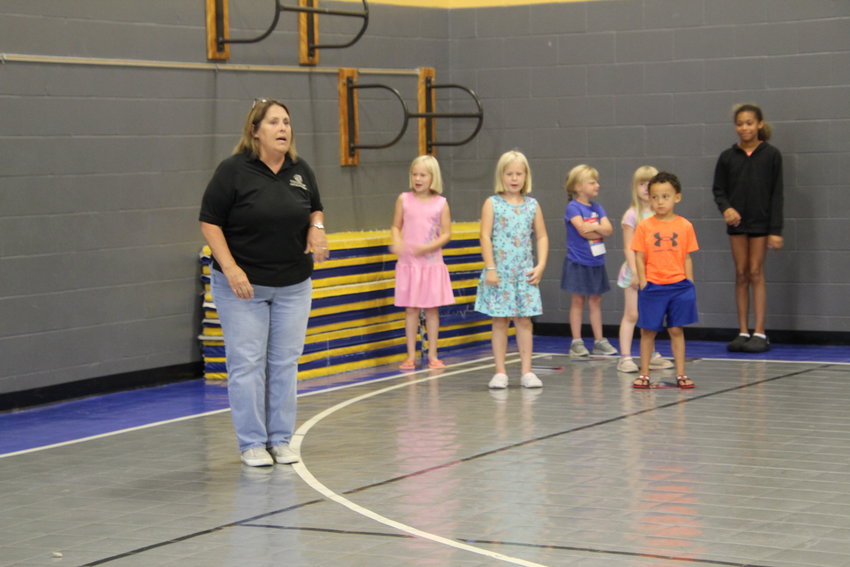 Boy &amp; Girls Clubs of West Central Missouri Skyline Director Vicki Hart dances along with the Parkview Elementary kindergarten through fourth grade children after the buddy reading session came to an end. All summer long club kids will have academic fun.