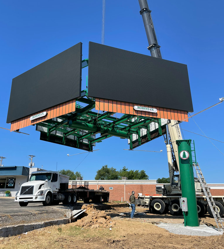 Robinson Outdoor lifts its four-sided display billboard into place at the corner of West Broadway Boulevard and South Limit Avenue on Tuesday. The 59,000-pound billboard was lifted into place Tuesday morning by a 240-ton crane.