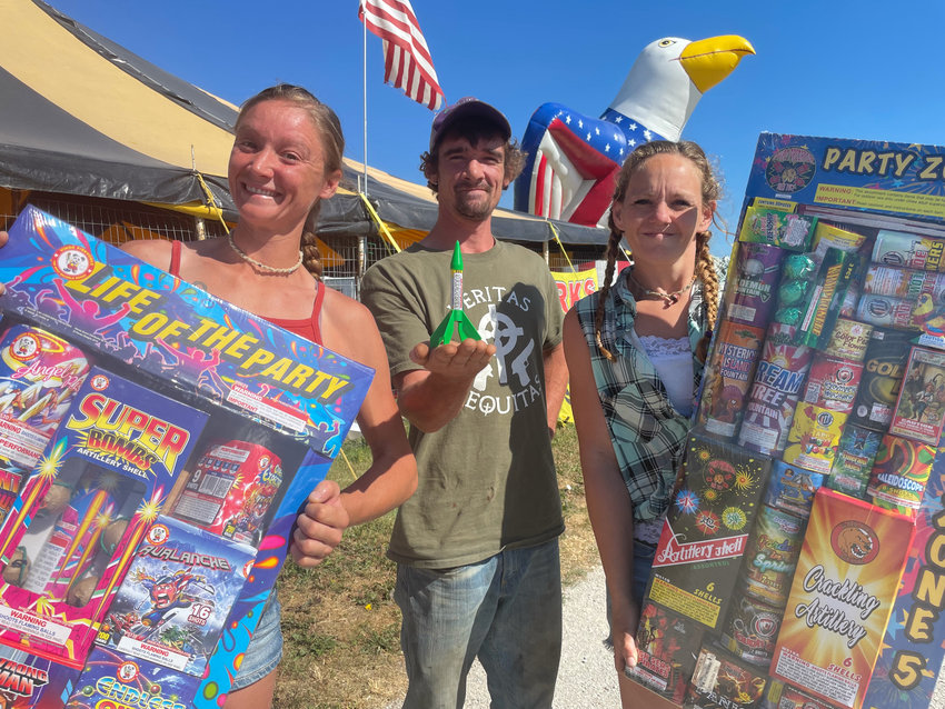 Clara Butler, John Butler and Ashleigh Johnson of Hale Fireworks say supply chain problems and inflation have caused some disruption in fireworks supplies, but they still have enough for customers to &ldquo;blow up the sky.&rdquo;
