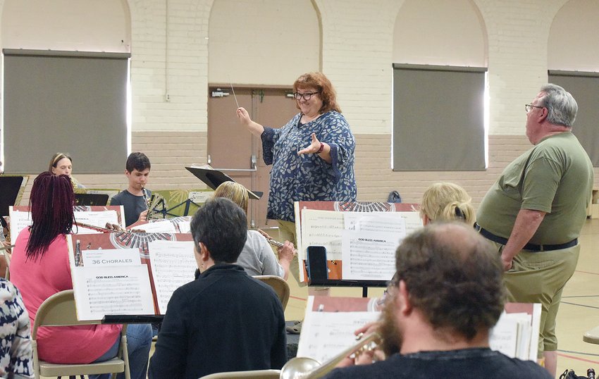 Thursday evening, Sandy Greene, the new director of the Sedalia Concert Band, directs band members as Richard DeFord sings &ldquo;America the Beautiful.&rdquo; The band rehearsed in Conventional Hall for its upcoming season, beginning at 7 p.m. Thursday, July 7, at Liberty Park.