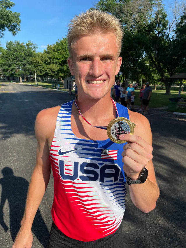 Firecracker Mile men&rsquo;s division winner Sam Wilhelm holds his first-place medal after smoking the field Monday at Liberty Park.