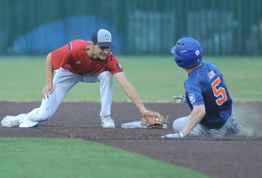 Travelers shortstop Tyler Ward tags out Jaxon Rogan, who is caught stealing second base in the second inning of Sunday night&rsquo;s game against Blue Springs Fike.