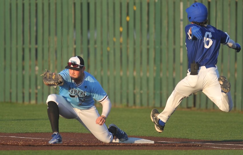 A throw to Sedalia Bombers first baseman Jake Baker beats Carroll&rsquo;s Andrew Schroeder for an out in Tuesday evening&rsquo;s game at Liberty Park Stadium. The visiting Merchants are the newest expansion team in the MINK League.