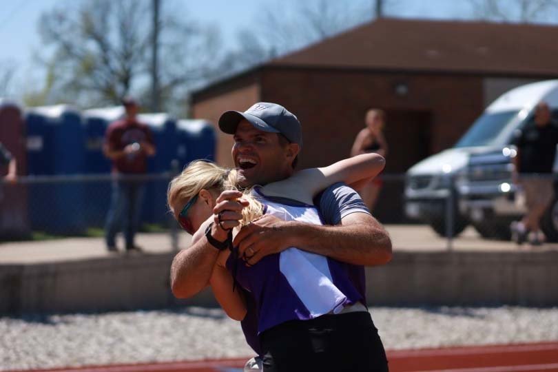 Lainy Williams, a track state champion at Cole Camp, receives a hug from Southwest Baptist University head coach Corey McElhaney.