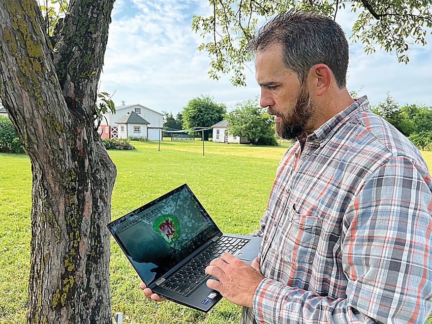 Chris Rippey, a certified arborist and owner of the Missouri Arborist Co., checks his laptop to see how healthy a tree is in his yard on Friday. Rippey, an arborist for Stanford University for 14 years and Seattle Parks for six, recently moved to Sedalia with his family.