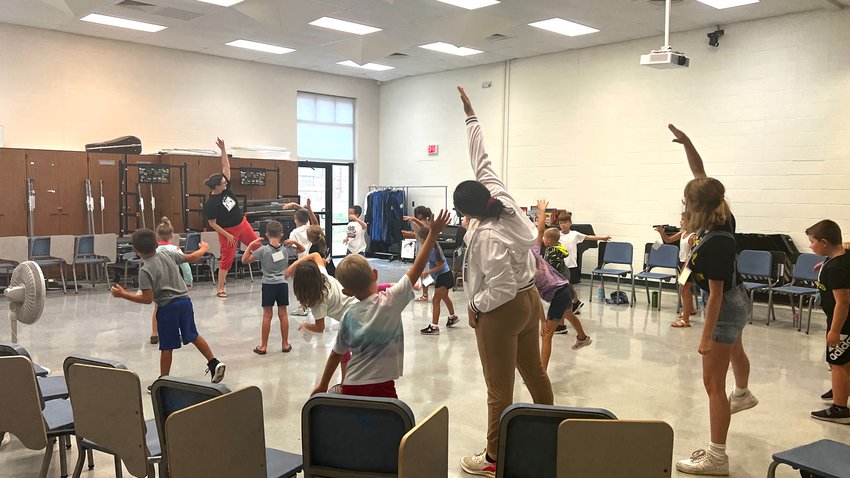 On Tuesday, campers join the theater teacher at Camp Blue Sky for some exercises. The camp will from till the end of the at State Fair Community College.