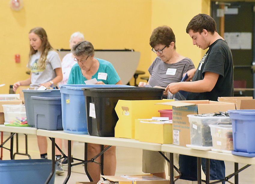 Volunteers for C.A.C.T.U.S. fill bags with school supplies in August 2017.