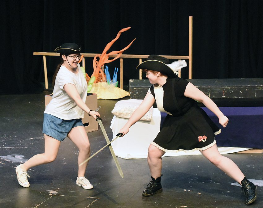 Capt. Scabbie, left, played by Lillibeth Sokolowski, has a sword fight with Capt. Evil Beard, played by Chloe Eckhoff, Wednesday afternoon at the Hayden Liberty Center. Students had a dress rehearsal for the upcoming play &ldquo;Captain Chris and the Magic Sketchbook.&rdquo;