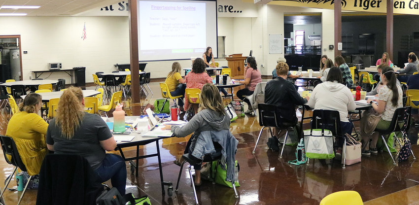 Sedalia 200 teachers review the technique of fingertapping syllables to assist with spelling during a Phonics First training session Tuesday, Aug. 2, at Smith-Cotton High School.