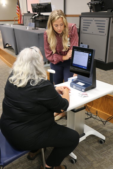Lindsey Graham, certified physician assistant at Bothwell Orthopedics &amp; Sports Medicine, performs a demo on the new EyeBOX concussion assessment device with an attendee at Bothwell&rsquo;s Athletic Injury Conference recently held at State Fair Community College.