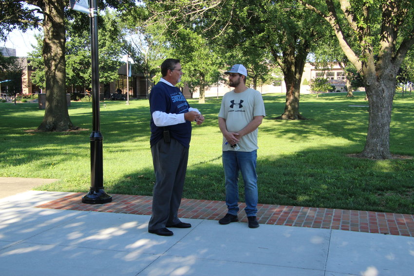 State Fair Community College President Brent Bates speaks with non-traditional student Ryan Rushing about his major in computers and minor in robotics on the first day of classes Monday. Bates, along with other members of SFCC, was wearing &ldquo;Ask Me&rdquo; shirts so students knew they could approach them for help.