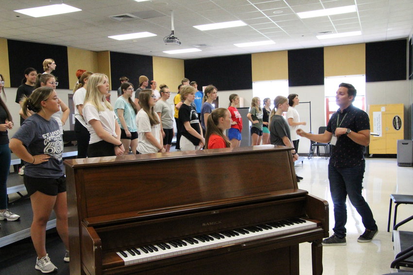 Smith-Cotton&rsquo;s New Score practices some vocal warm-ups during Tuesday evening&rsquo;s choreography camp. The choir is learning choreography before learning the music due to choreographer availability.