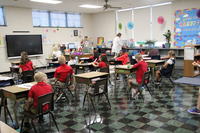 Jennifer Walker&rsquo;s third grade class hangs out in their classroom at Sacred Heart before the all-school mass begins on Thursday morning. Sacred Heart began its first day of school on Thursday.