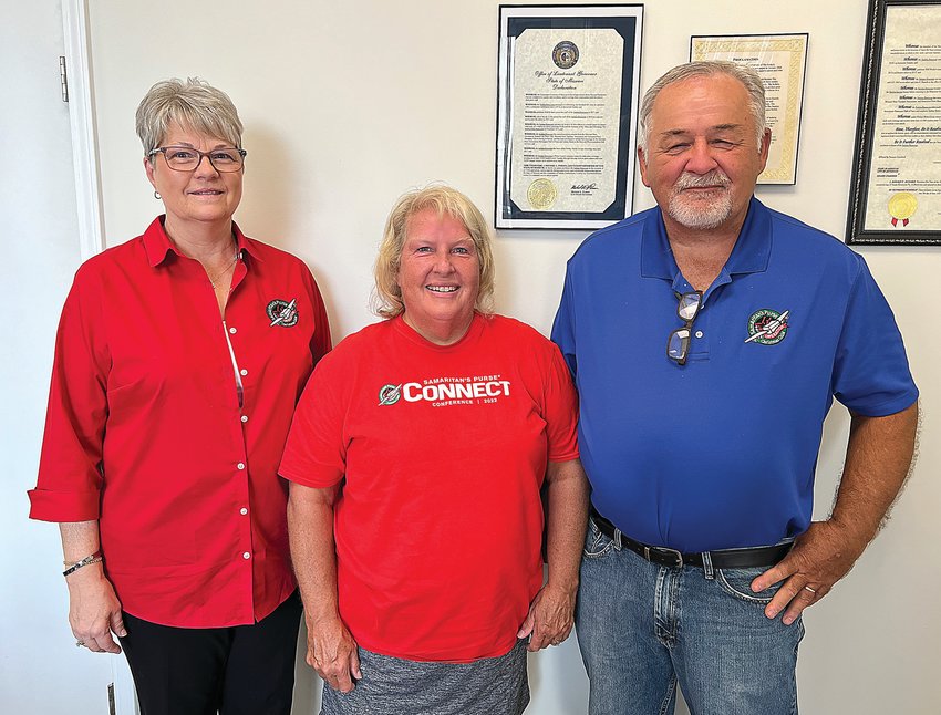 From left, Sheila Guier, Sherry, and Keith Sumner, all of Sedalia, pose for a photo on Thursday. The trio are volunteers with Pettis County Operation Christmas Child. Over 20 local churches are responsible for packing gift boxes for children worldwide each year.