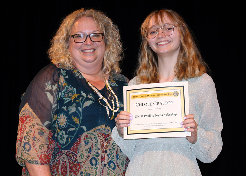 Smith-Cotton High School Counselor Pam Crafton, left, presents her granddaughter, Chloee, the C.H. &amp; Pauline Joy Scholarship during Senior Awards Night on May 4 in the Heckart Performing Arts Center. Pam Crafton died unexpectedly on Monday, Sept. 26.